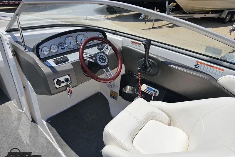 Slide: The Image of 2007 Regal 2000 Bowrider boat interior with steering wheel and control panel. - 59