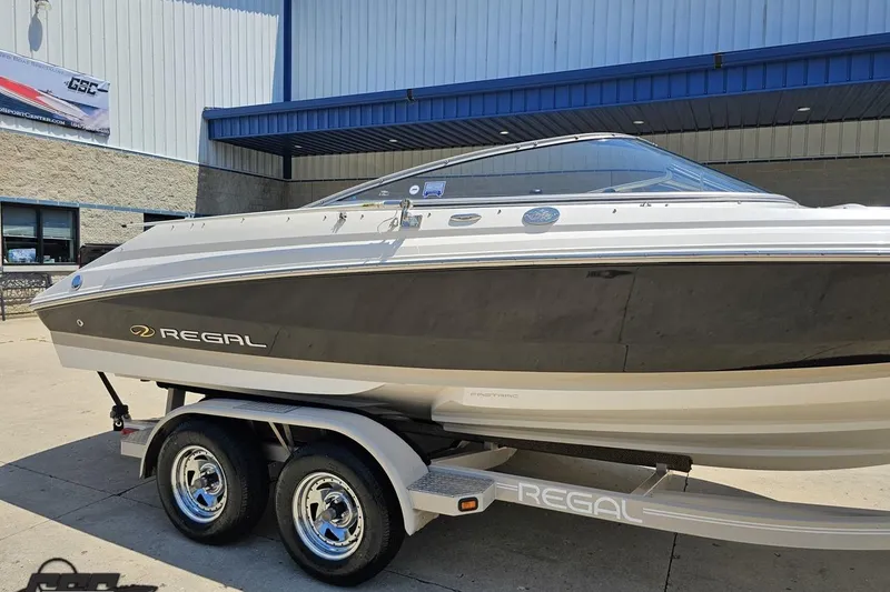 Slide: The Image of 2007 Regal 2000 Bowrider boat on trailer, parked outside a building. - 6
