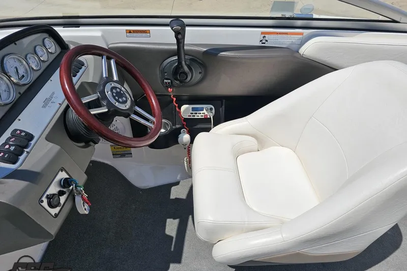 Slide: The Image of 2007 Regal 2000 Bowrider cockpit with white seat and wooden steering wheel. - 60