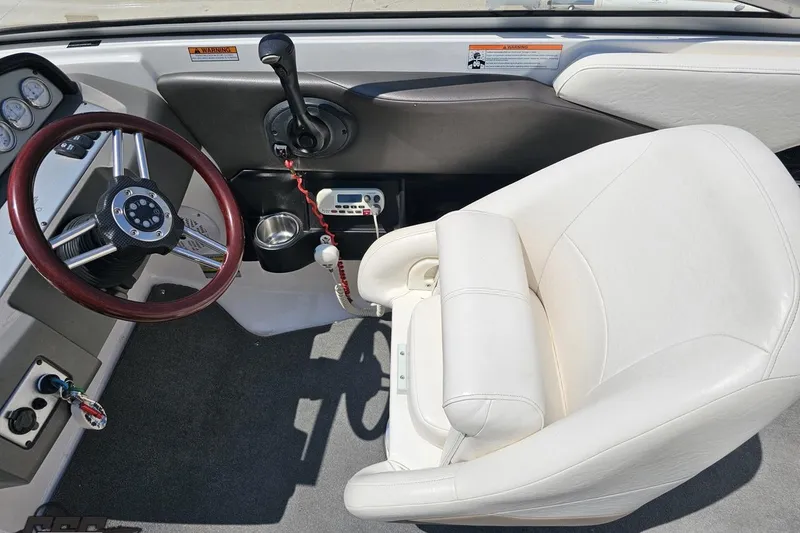 Slide: The Image of 2007 Regal 2000 Bowrider cockpit with steering wheel and white captain's chair. - 61