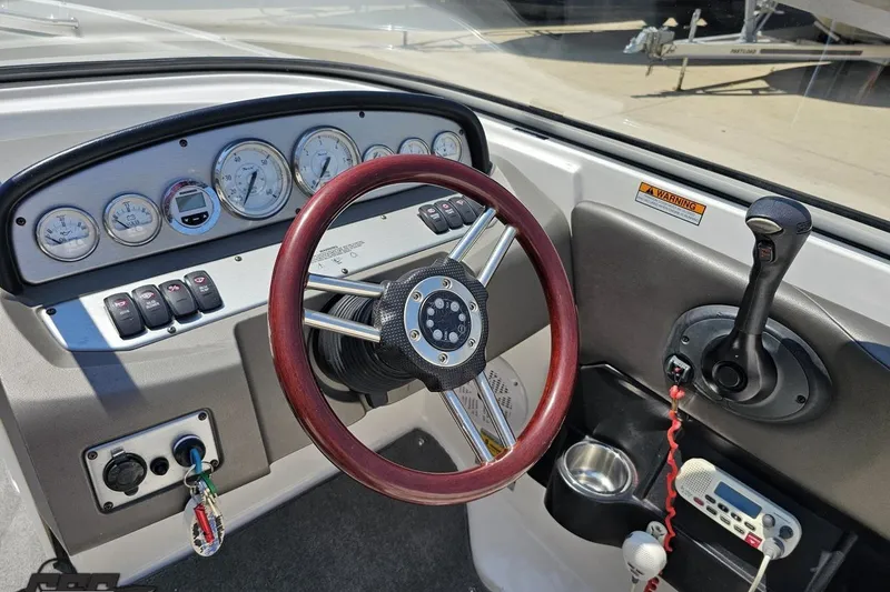 Slide: The Image of 2007 Regal 2000 Bowrider dashboard with steering wheel and control panel. - 62