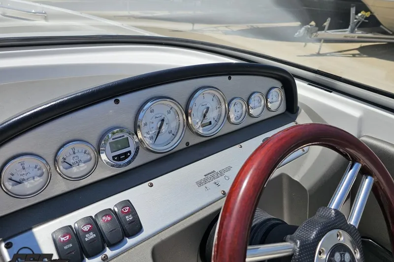 Slide: The Image of Dashboard of a 2007 Regal 2000 Bowrider boat with gauges and wooden steering wheel. - 63