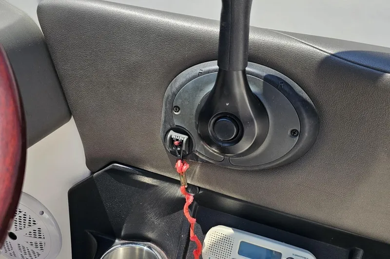 Slide: The Image of 2007 Regal 2000 Bowrider dashboard with throttle control and safety lanyard. - 67