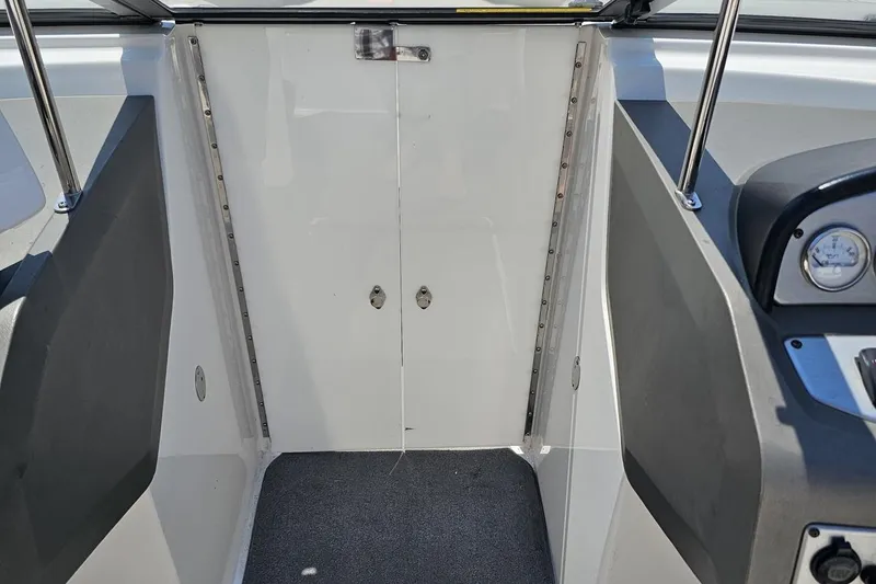 Slide: The Image of 2007 Regal 2000 Bowrider interior with closed cabin door and dashboard view. - 69