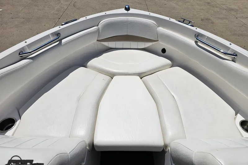 Slide: The Image of 2007 Regal 2000 Bowrider boat interior with white cushioned seating and stainless steel handles. - 72