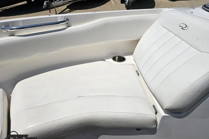 Slide: The Image of 2007 Regal 2000 Bowrider boat interior with white seating and cup holder. - 77