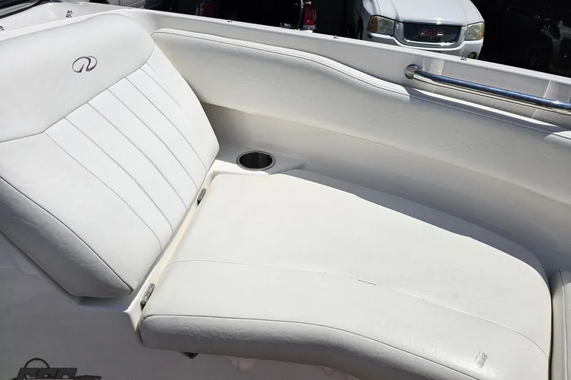 Slide: The Image of 2007 Regal 2000 Bowrider boat interior with white seating and cup holder. - 82
