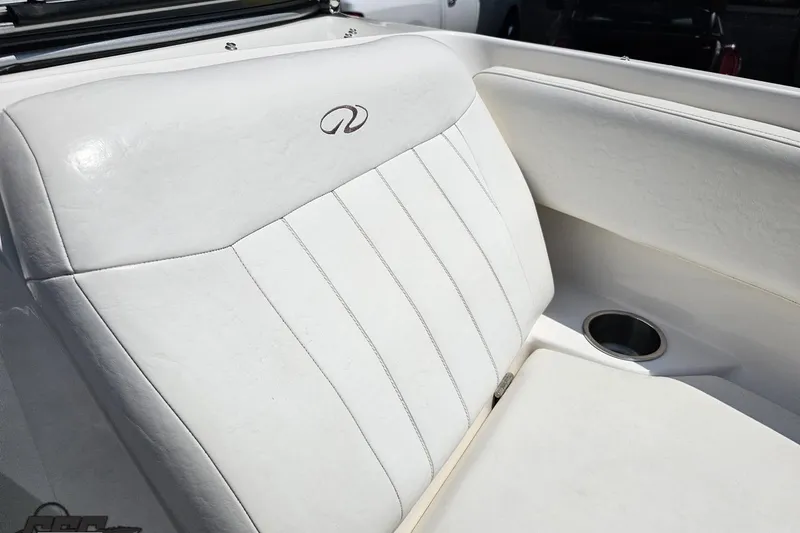 Slide: The Image of White leather seating in a 2007 Regal 2000 Bowrider boat with cup holder. - 83