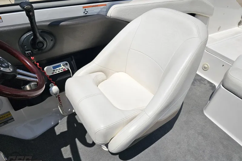 Slide: The Image of 2007 Regal 2000 Bowrider interior with white captain's chair and steering wheel. - 92