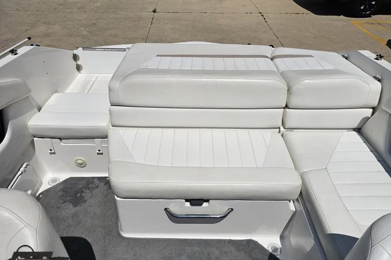 Slide: The Image of 2007 Regal 2000 Bowrider interior with white cushioned seating and carpeted flooring. - 94