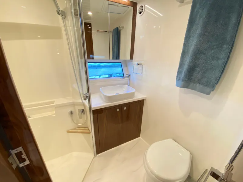 Slide: The Image of Luxurious bathroom in 2025 Riviera 465 SUV yacht with modern fixtures and elegant design. - 23