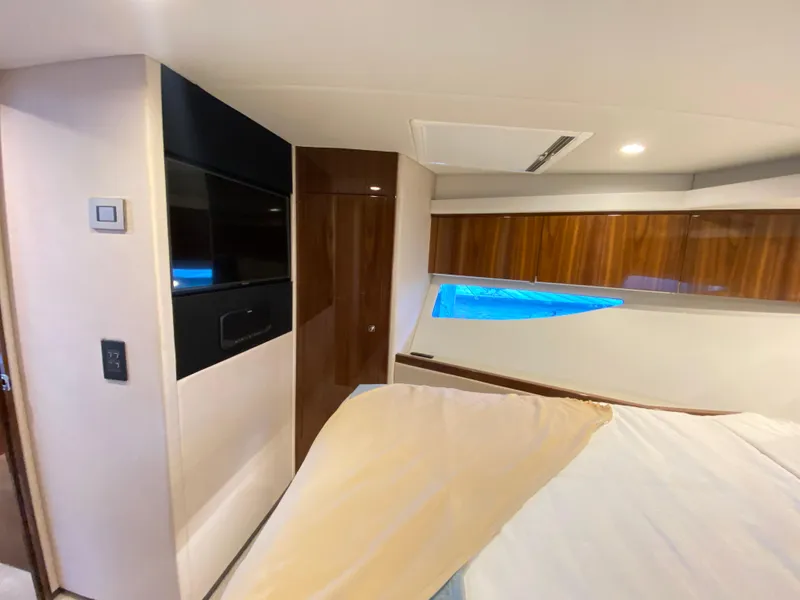 Slide: The Image of Interior of 2025 Riviera 465 SUV yacht, featuring modern design and wood accents. - 24