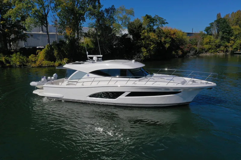 Slide: The Image of 2025 Riviera 465 SUV yacht cruising on a serene river. - 25