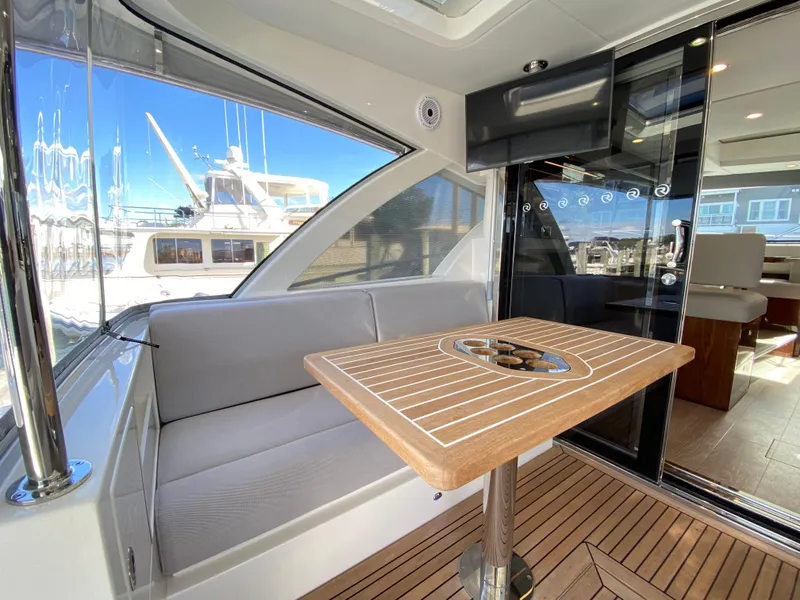 Slide: The Image of Luxurious interior of 2025 Riviera 465 SUV yacht with elegant seating and wooden table. - 4