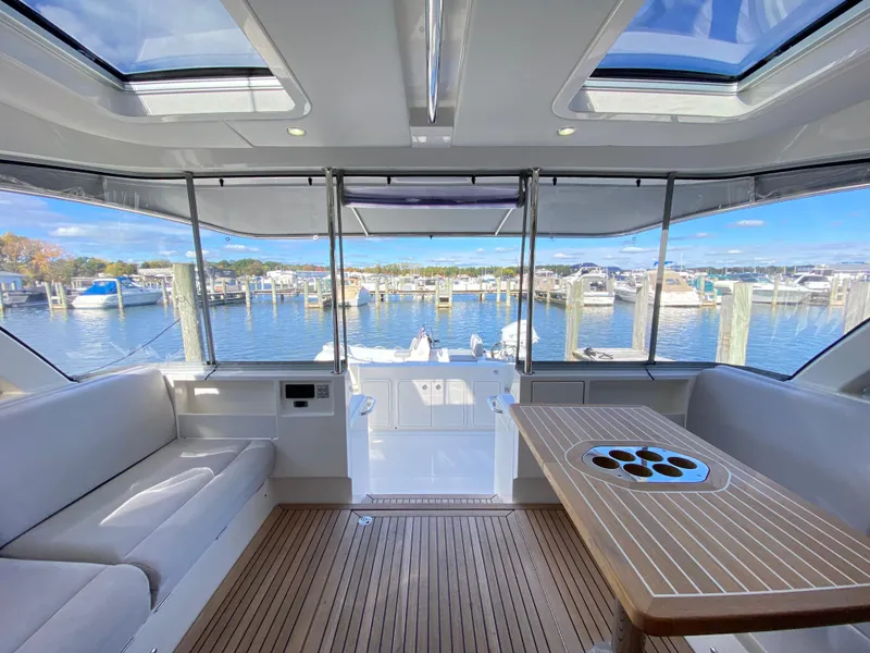 Slide: The Image of Luxurious interior of 2025 Riviera 465 SUV yacht with scenic marina view. - 5