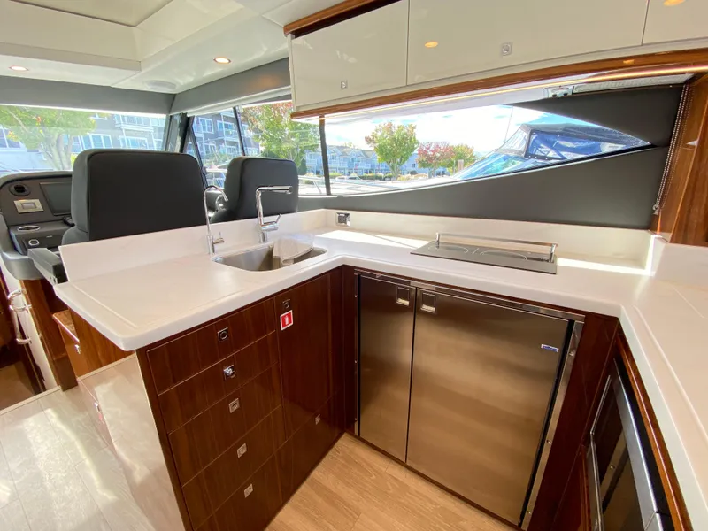 Slide: The Image of Luxurious interior of 2025 Riviera 465 SUV yacht with modern kitchen amenities. - 9