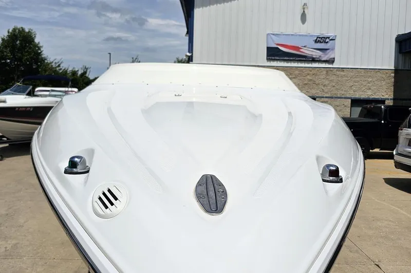 Slide: The Image of 2005 Baja 245 boat front view at a marina under clear skies. - 15