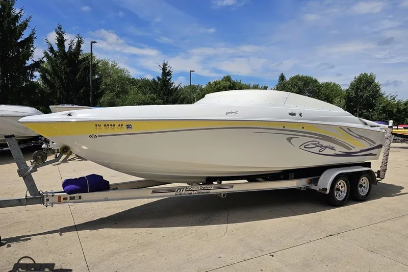 Slide: The Image of 2005 Baja 245 speedboat on trailer, parked outdoors under a clear sky. - 17