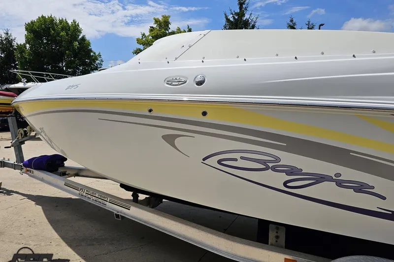 Slide: The Image of 2005 Baja 245 boat on trailer, featuring sleek design and vibrant graphics. - 22