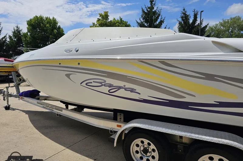 Slide: The Image of 2005 Baja 245 boat on trailer, featuring sleek design and vibrant graphics. - 23