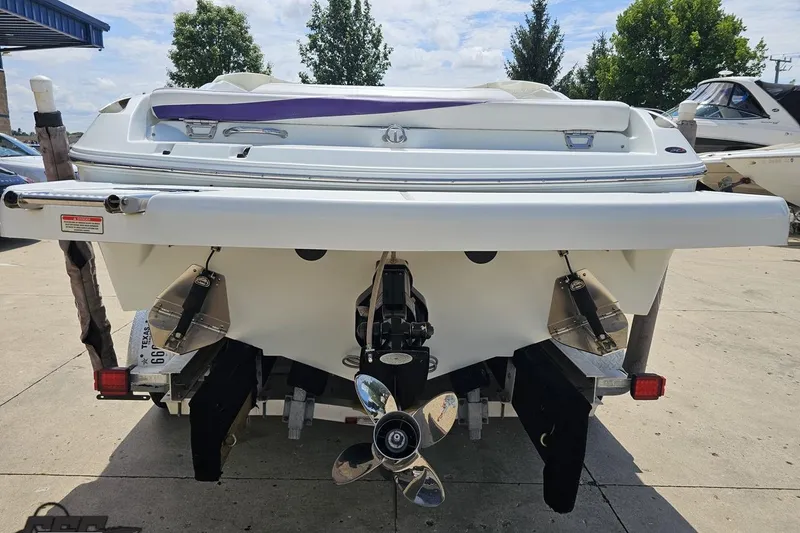 Slide: The Image of Rear view of a 2005 Baja 245 boat with dual propellers. - 26
