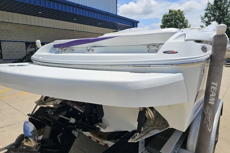 Slide: The Image of 2005 Baja 245 boat on trailer, rear view, showcasing sleek design and powerful engine. - 28