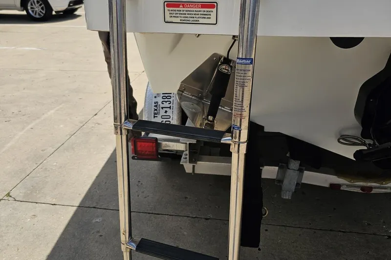 Slide: The Image of Rear view of a 2005 Baja 245 boat with a metal boarding ladder. - 30