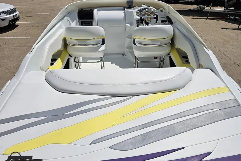 Slide: The Image of 2005 Baja 245 boat interior with white, yellow, and gray seating design. - 35
