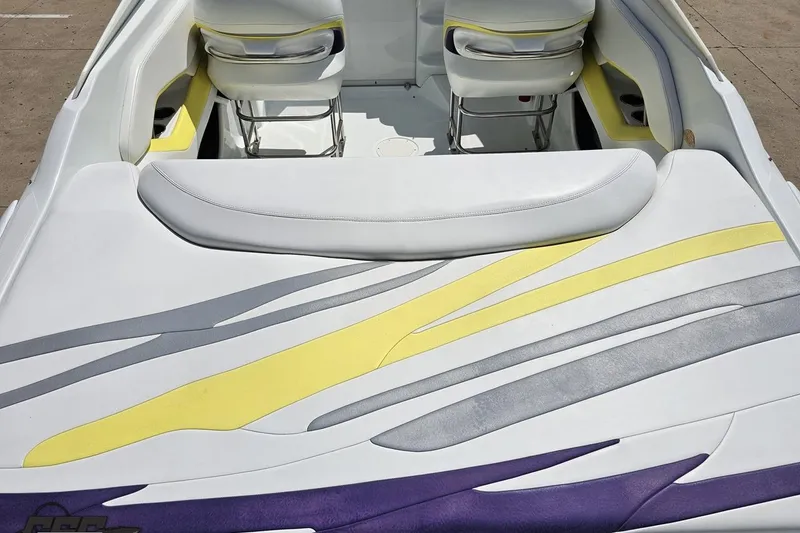 Slide: The Image of 2005 Baja 245 boat interior with colorful seat design and sleek upholstery. - 36