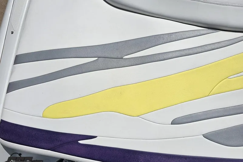 Slide: The Image of Baja 245 2005 boat seat with white, gray, yellow, and purple design. - 37
