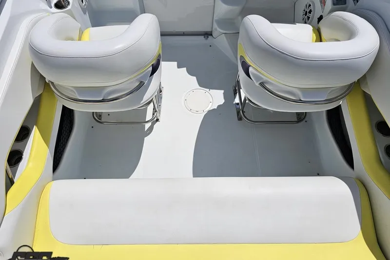 Slide: The Image of Interior of a 2005 Baja 245 boat with white and yellow seating. - 42