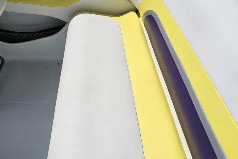 Slide: The Image of Interior seating of a 2005 Baja 245 boat with yellow and white upholstery. - 43