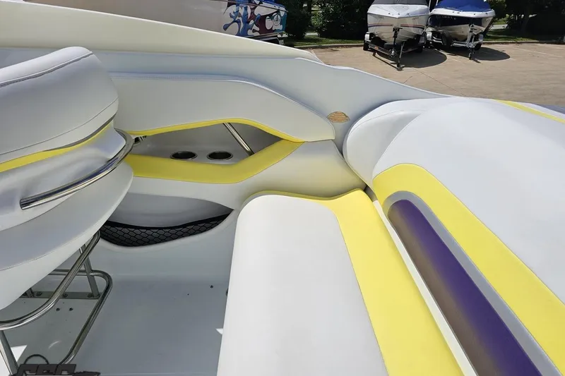 Slide: The Image of Interior of a 2005 Baja 245 boat with white and yellow seating. - 45