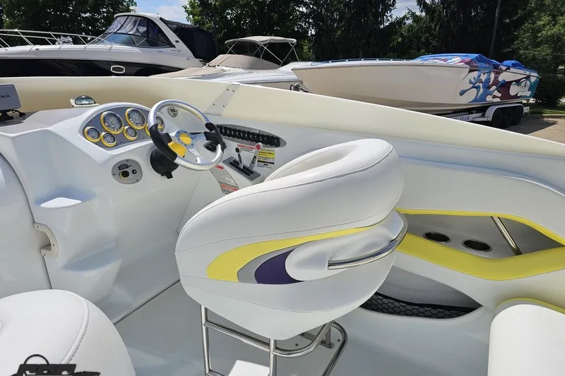 Slide: The Image of Interior of a 2005 Baja 245 boat with white and yellow seating. - 46