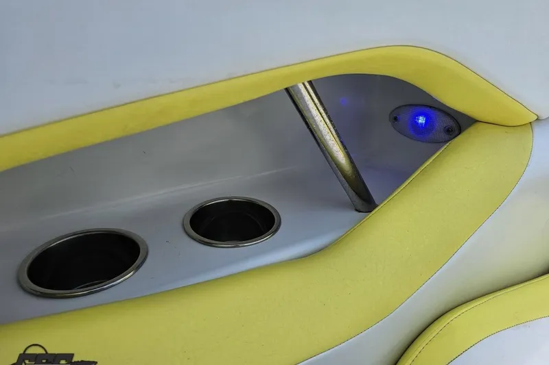 Slide: The Image of Interior of a 2005 Baja 245 boat with cup holders and blue LED light. - 49