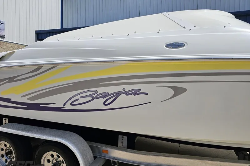 Slide: The Image of 2005 Baja 245 boat with colorful graphics on a trailer. - 5