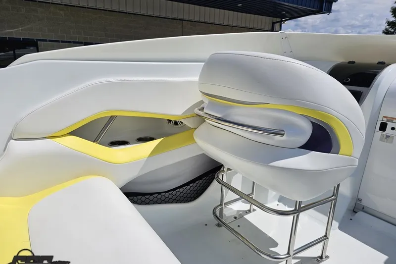 Slide: The Image of 2005 Baja 245 boat interior with white and yellow seating, stainless steel accents. - 51