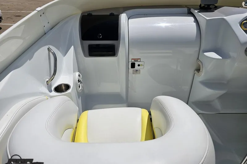 Slide: The Image of Interior of a 2005 Baja 245 boat featuring white and yellow seating. - 56
