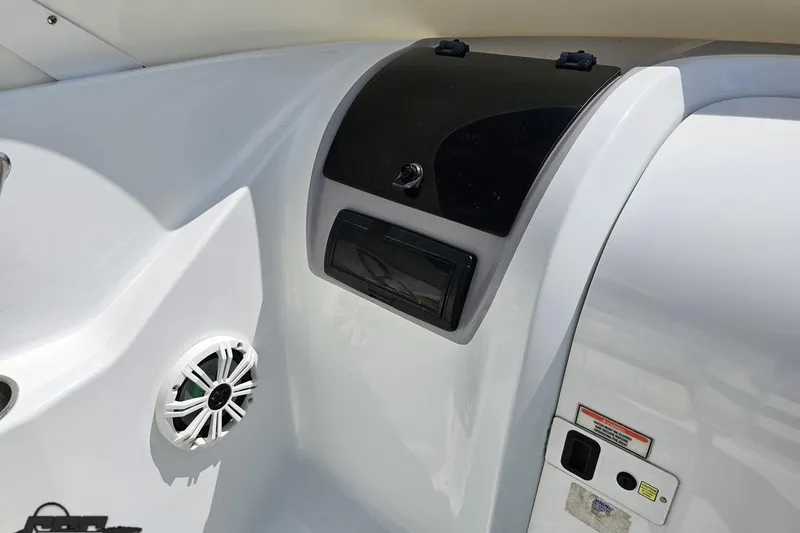 Slide: The Image of Interior of a 2005 Baja 245 boat showing speaker and control panel. - 57