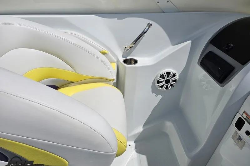 Slide: The Image of Interior of 2005 Baja 245 boat with white and yellow seating, speaker, and cup holder. - 58