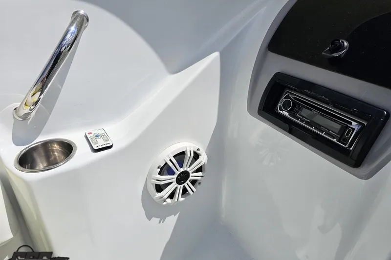 Slide: The Image of 2005 Baja 245 boat interior with stereo, speaker, and cup holder. - 59