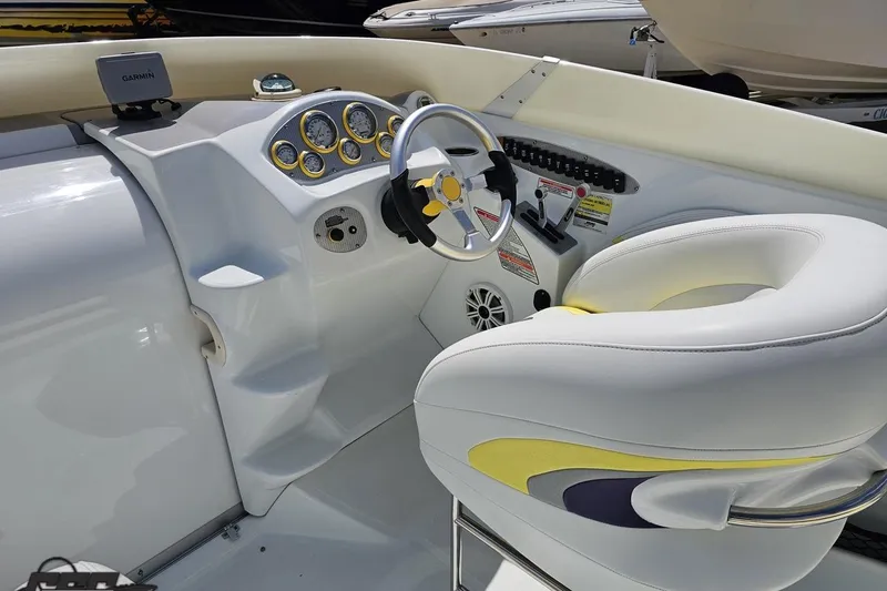 Slide: The Image of Interior of a 2005 Baja 245 boat with steering wheel and dashboard controls. - 61