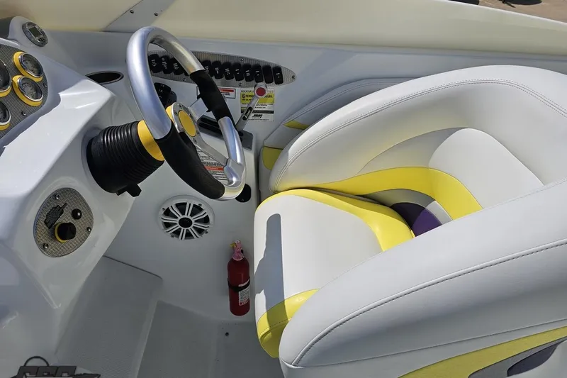 Slide: The Image of Interior of 2005 Baja 245 boat with steering wheel and colorful seating. - 62
