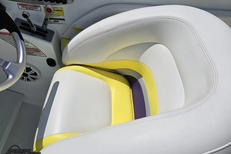 Slide: The Image of 2005 Baja 245 boat interior with colorful seat and steering wheel. - 63