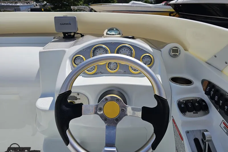 Slide: The Image of Steering wheel and dashboard of a 2005 Baja 245 boat with Garmin GPS. - 64