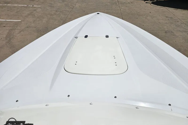 Slide: The Image of Bow view of a 2005 Baja 245 boat, showcasing sleek white design. - 69
