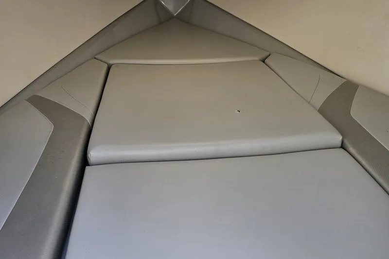 Slide: The Image of Interior view of a 2005 Baja 245 boat cabin with cushioned seating. - 70