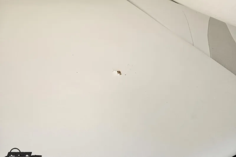 Slide: The Image of 2005 Baja 245 boat surface with a small chip or damage visible. - 72