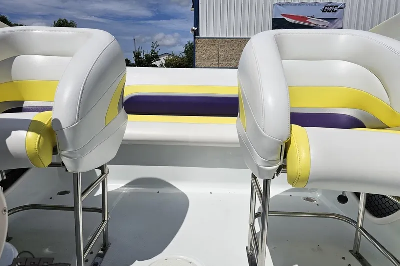 Slide: The Image of Interior of a 2005 Baja 245 boat with white, yellow, and purple seating. - 75