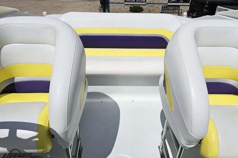 Slide: The Image of Interior of 2005 Baja 245 boat with white, yellow, and purple seating. - 76
